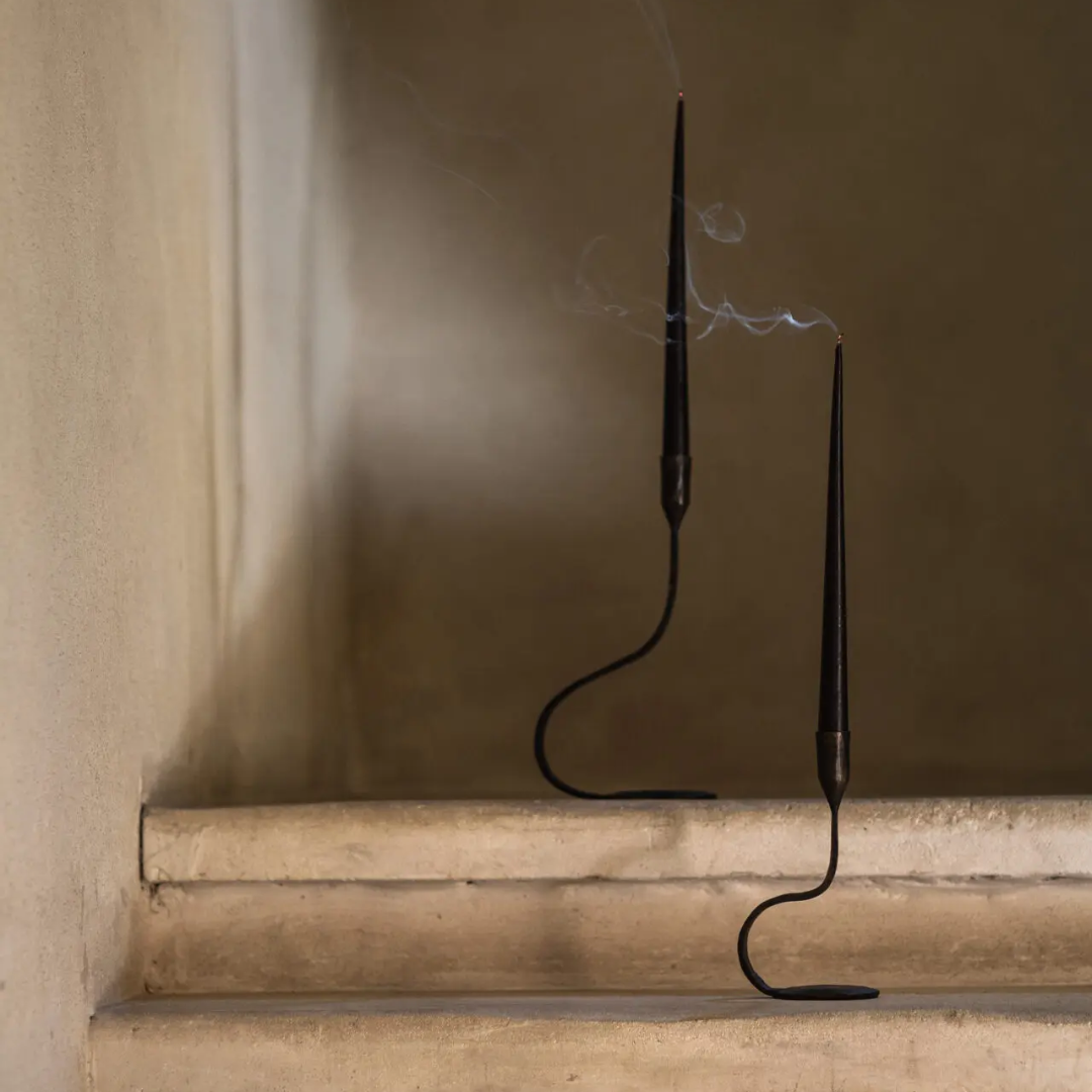 Twee Steffi kaarshouders met zwarte kaarsen op een stenen trap